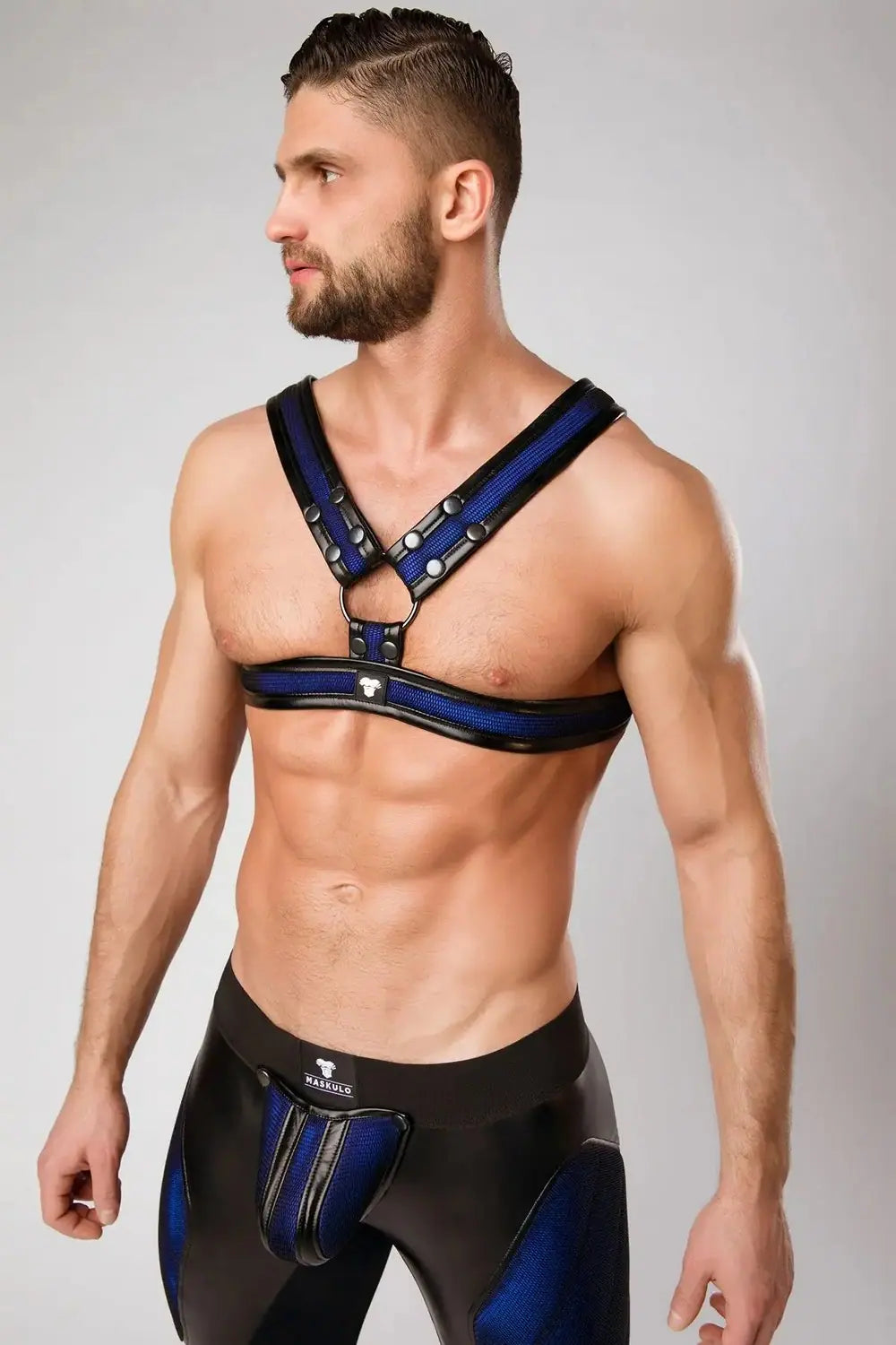 Maskulo blue-royal Chest X-harness for men with black mesh, PU leather piping, and color-glowing effect, appealing to young urban customers and rainbow explorers, Armored Color-Under