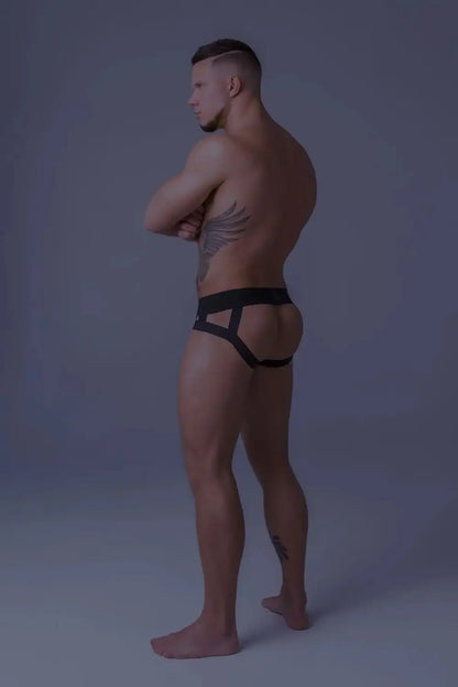 Maskulo Youngero orange-neon fetish jockstrap with black mesh codpiece and UV glowing accents for men