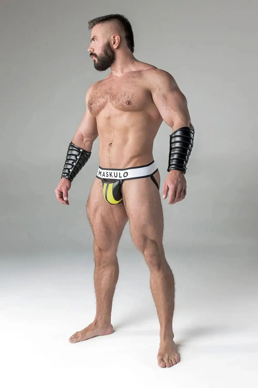 Maskulo Armored yellow Jockstrap for men with detachable codpiece, black shiny leather-look padding, and white waistband for urban Gen Z style